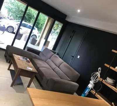 a living room with a couch and a table at Joli T1 à ne pas manquer in Borgo