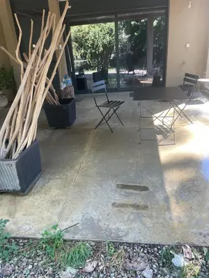 a patio with a table and chairs in front of a building at Joli T1 à ne pas manquer in Borgo
