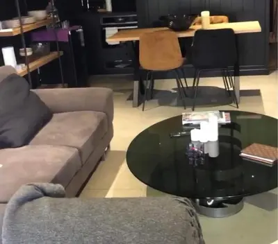 a living room with a couch and a glass table at Joli T1 à ne pas manquer in Borgo