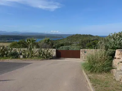 a driveway with a fence and a road at Boccamanza in Bonifacio