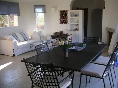 a living room with a black table and chairs at Boccamanza in Bonifacio
