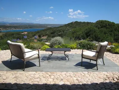 two chairs and a coffee table on a patio at Boccamanza in Bonifacio