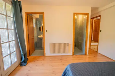 a room with a bed and a bathroom with a mirror at Sud-corse bavella location montagne et mer in Sorbollano