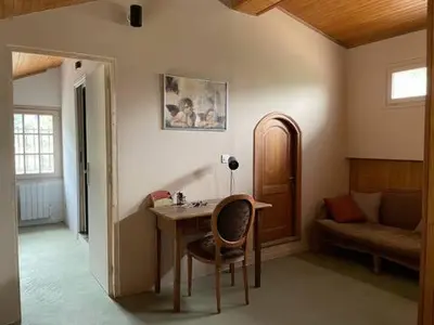 a room with a table and a chair and a couch at Sud-corse bavella location montagne et mer in Sorbollano
