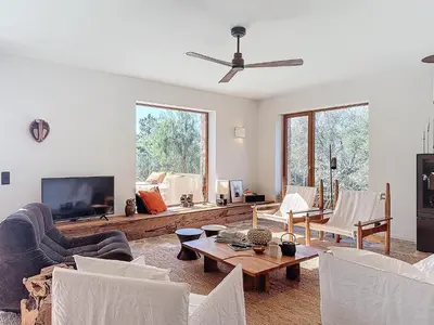 a living room with white furniture and a flat screen tv at Villas Inamorata in Lecci