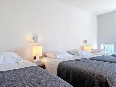 two beds in a room with two lamps on them at Villas Inamorata in Lecci