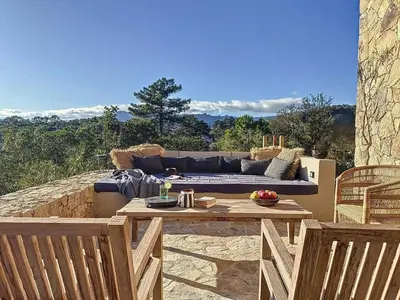a patio with a couch and a table and chairs at Villas Inamorata in Lecci
