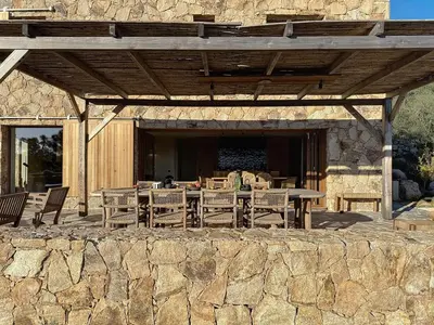 a stone patio with a table and chairs at Villas Inamorata in Lecci