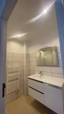 a white bathroom with a sink and a mirror at Le Petit paradis in Aregno