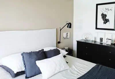 a bedroom with a white bed with blue pillows at Villa pour 8 avec piscine in Compoli
