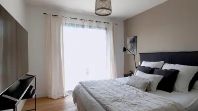 a bedroom with a large bed with a large window at Villa pour 8 avec piscine in Compoli