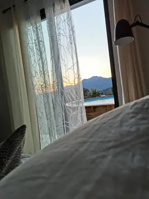 a bedroom with a bed and a window with a view at Villa pour 8 avec piscine in Compoli