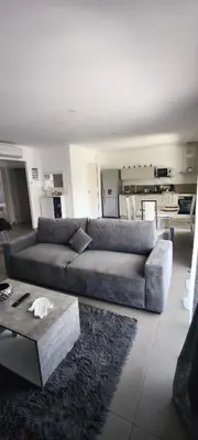 a living room with a couch and a table at Résidence privée avec piscine à Bonifacio in Bonifacio