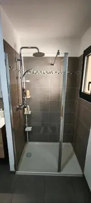 a shower with a glass door in a bathroom at Résidence privée avec piscine à Bonifacio in Bonifacio
