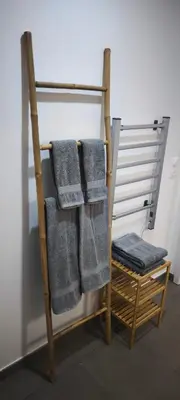 a towel rack with four towels on it at Résidence privée avec piscine à Bonifacio in Bonifacio