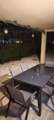 a black table and chairs in a patio at Résidence privée avec piscine à Bonifacio in Bonifacio