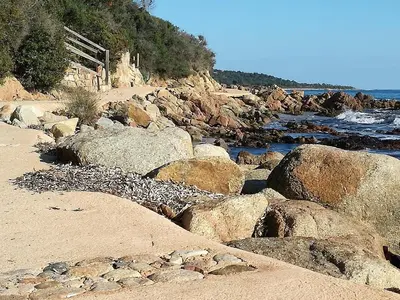 a group of rocks on a beach near the water at Corse du Sud Villa les pieds dans l'eau ! in Zonza