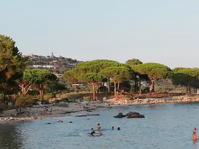 a group of people in the water at a beach at Corse du Sud Villa les pieds dans l'eau ! in Zonza