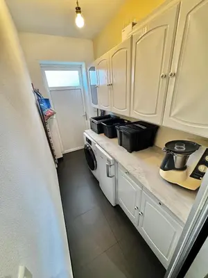a kitchen with white cabinets and a washer and dryer at Villa à Porto-Vecchio - Résidence privé in Porto-Vecchio