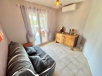 a living room with a couch and a window at Villa à Porto-Vecchio - Résidence privé in Porto-Vecchio