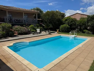 a swimming pool in front of a house at Villa à Porto-Vecchio - Résidence privé in Porto-Vecchio