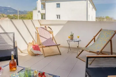 a patio with two chairs and a table on a balcony at Casa Verde in San-Nicolao