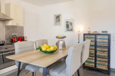a dining room table with chairs and a bowl of fruit at Casa Verde in San-Nicolao