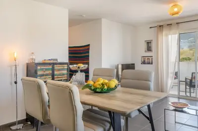 a dining room with a table with a bowl of fruit on it at Casa Verde in San-Nicolao