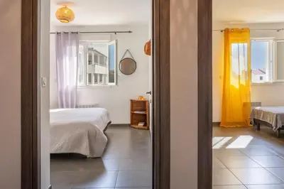 a bedroom with two beds and a mirror at Casa Verde in San-Nicolao