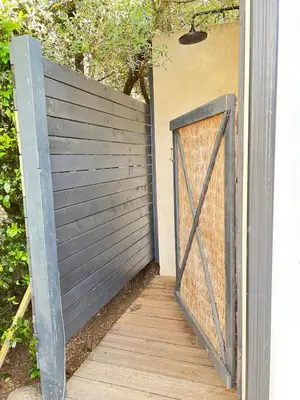 a wooden gate with a wooden walkway with a fence at Beautiful villa, pool, sea, 5 bedrooms in Zonza