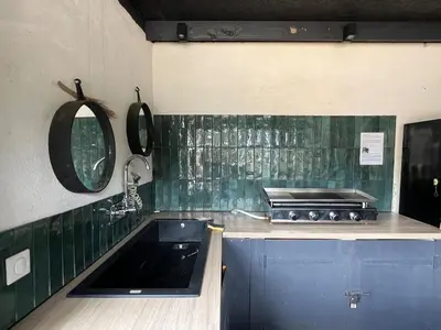 a green tiled kitchen with a sink and a mirror at Beautiful villa, pool, sea, 5 bedrooms in Zonza