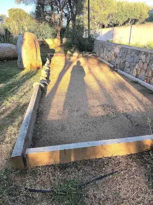a road with a shadow on the ground at Beautiful villa, pool, sea, 5 bedrooms in Zonza