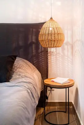 a table next to a bed and a lamp at Beautiful villa, pool, sea, 5 bedrooms in Zonza