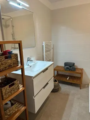 a bathroom with a sink and a mirror at I Sognu - Charmant Appartement Neuf Proche du Port in Porto-Vecchio