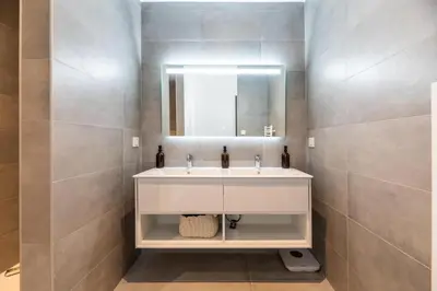 a bathroom with a white sink and a mirror at VILLA VITRICCIA - VILLA DE REVE, PISCINE et PLAGE à 7MN A PIED ! in Zonza