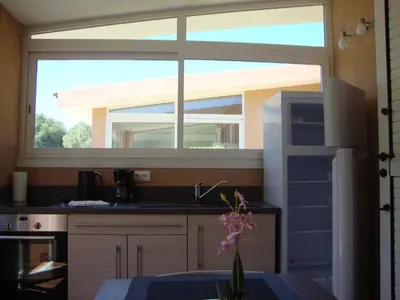a kitchen with a large window above a sink at Camping Residence Chalet La Pomposa Terrazzoni in Bonifacio