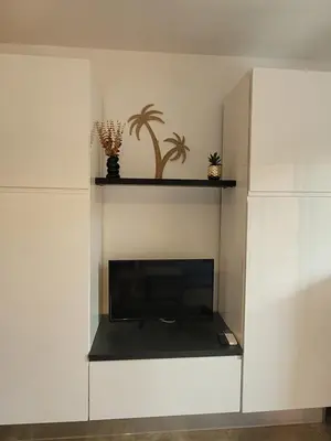 a living room with a fireplace and a tv at Studio Port de Porto-Vecchio in Porto-Vecchio