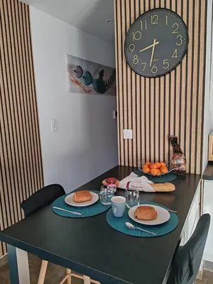 a table with plates of food on it with a clock at Studio Port de Porto-Vecchio in Porto-Vecchio