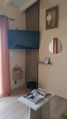 a living room with a couch and a table at La mini villa Ondella à Porticcio in Grosseto-Prugna
