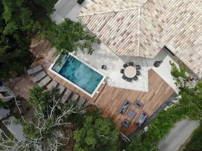 an overhead view of a swimming pool with a wooden deck at CASA MILO- with private pool Porto-Vecchio in Porto-Vecchio