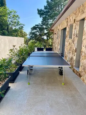 a ping pong table sitting on a patio at CASA MILO- with private pool Porto-Vecchio in Porto-Vecchio