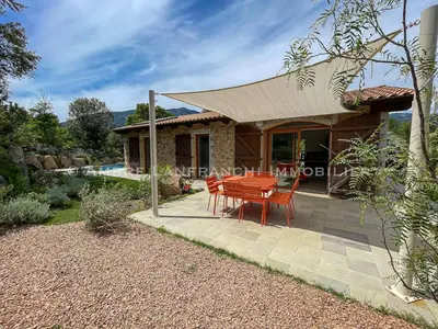 a house with a table and chairs on a patio at Maison en pierre - 6 personnes - piscine in Porto-Vecchio