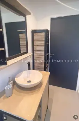 a bathroom with a white sink on a counter at Maison en pierre - 6 personnes - piscine in Porto-Vecchio