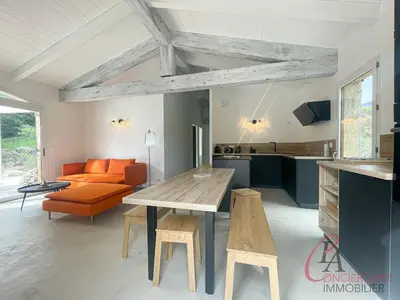 a living room with a table and an orange couch at Maison en pierre - 6 personnes - piscine in Porto-Vecchio
