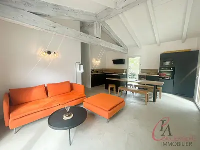 a living room with an orange couch and a table at Maison en pierre - 6 personnes - piscine in Porto-Vecchio