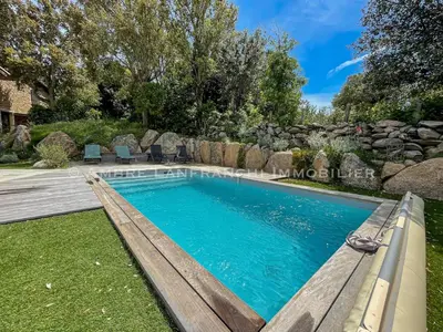 a swimming pool with a bench next to a yard at Maison en pierre - 6 personnes - piscine in Porto-Vecchio