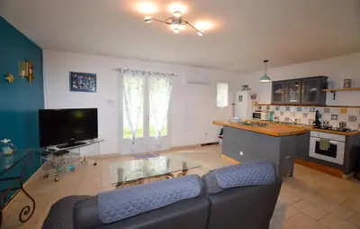 a living room with a couch and a table and a kitchen at 1 Bedroom Nice Home In Vignale in Vignale