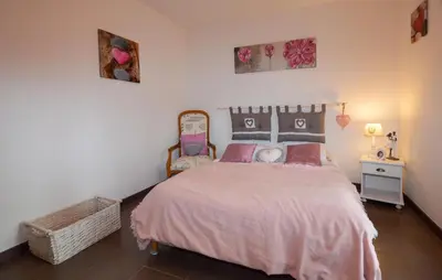 a bedroom with a bed with a pink bedspread at 1 Bedroom Nice Home In Vignale in Vignale