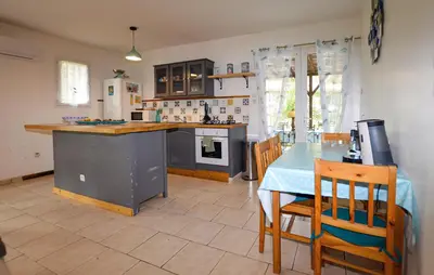 a kitchen and dining room with a table and chairs at 1 Bedroom Nice Home In Vignale in Vignale