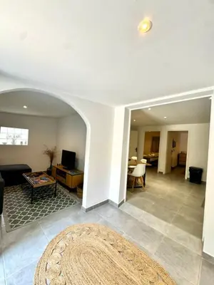 a living room with a couch and a table at Maison avec jardin et proche mer in Propriano